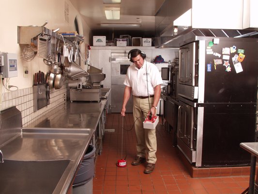 ALD technician looking for leak in kitchen